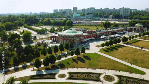 Top view of palace with park on background of modern city. Creative. Beautiful country palace with garden on sunny summer day. Tsaritsyno Museum Reserve