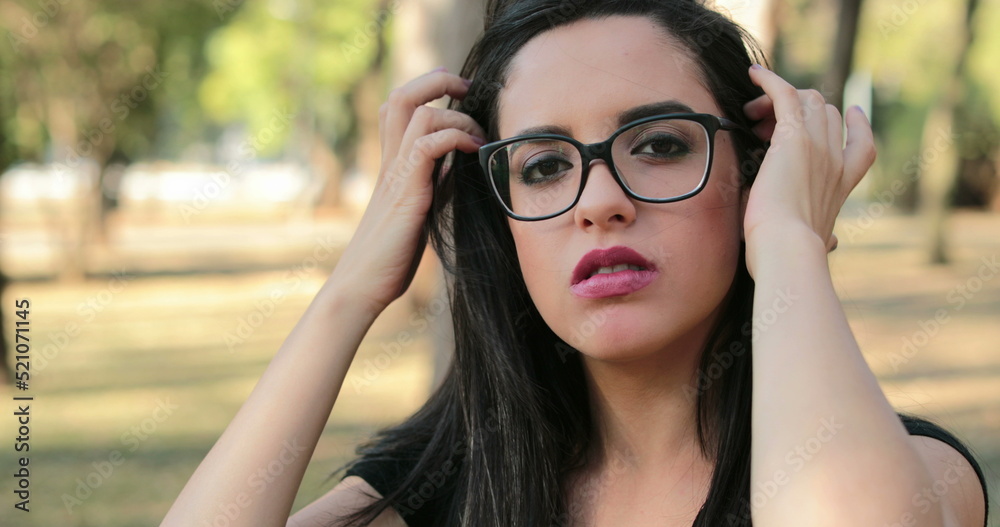 woman wearing glasses looking to camera with a serious smart expression woman wearing glasses looking to camera with a serious smart expression