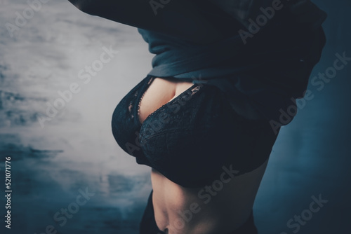 Wall Mural young woman in bra takes off her t-shirt