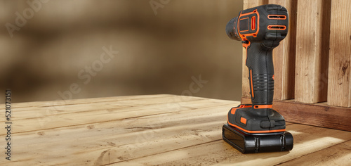 Black and orange drill on wooden table and free space for your decoration. 