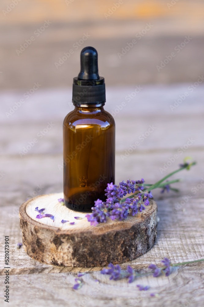 a bottle for cosmetics with an empty space for advertising lavender flowers on a wooden background A place for copying A place for advertising a bottle for cosmetics with an empty space for advertising lavender flowers on a wooden background A place for copying A place for advertising