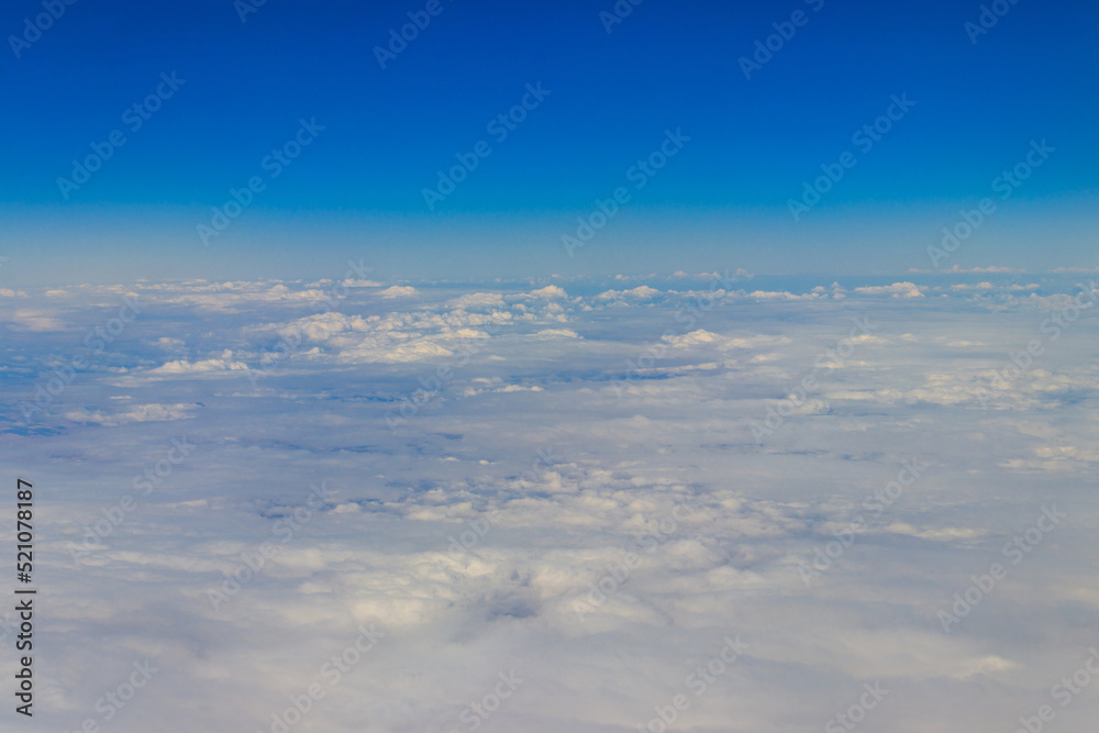 Fototapeta premium Beautiful white clouds in blue sky. View from airplane