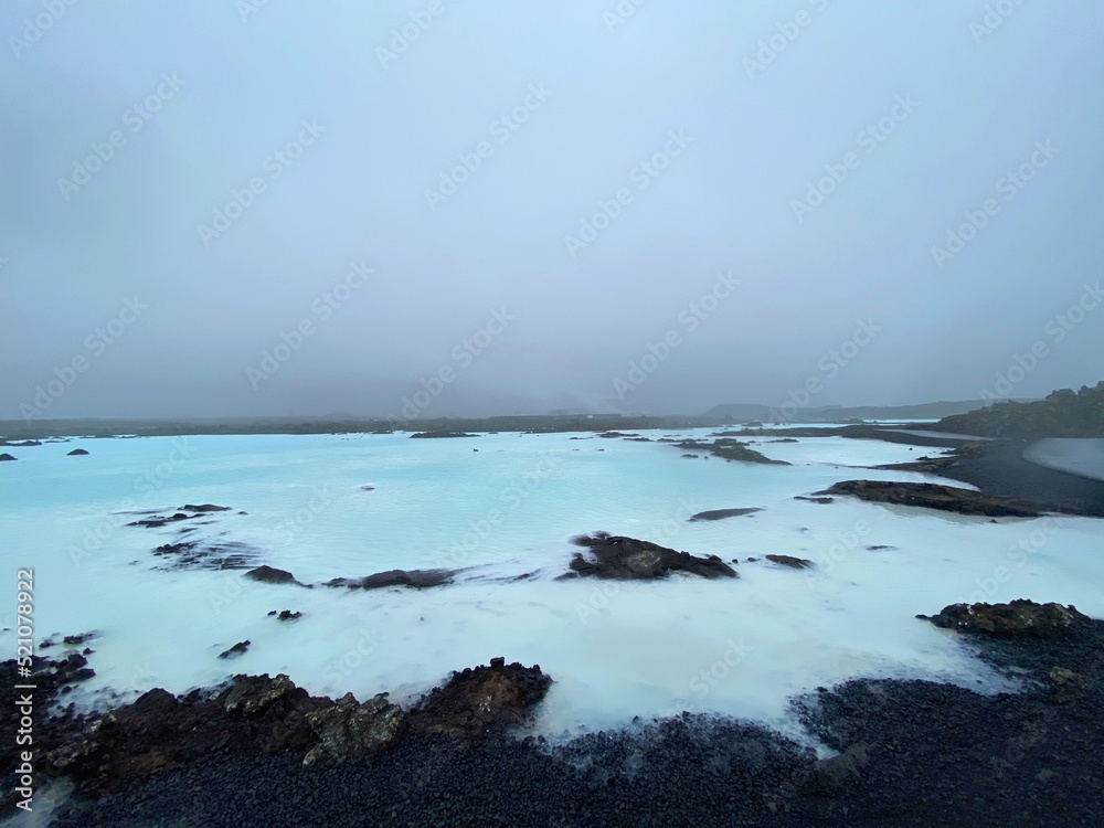 Obraz premium Back rocks and blue water in Iceland near the Blue Lagoon in the fog