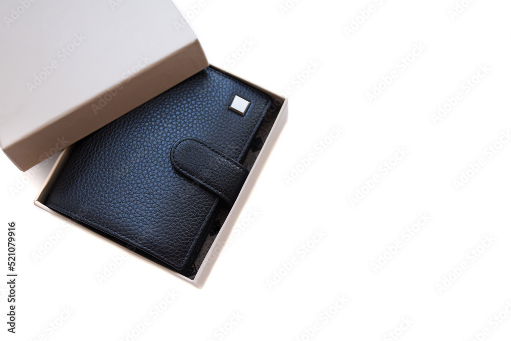 On a white background there is a gift box with a good, expensive wallet made of black genuine leather. A gift for a man. On a white background there is a gift box with a good, expensive wallet made of black genuine leather. A gift for a man.