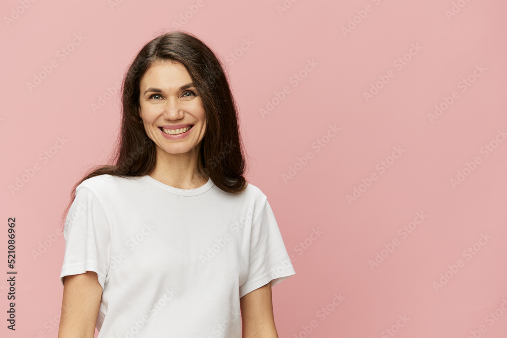 horizontal portrait of a cute attractive woman on a pink background in a clean white tank top smiling pleasantly at the camera horizontal portrait of a cute attractive woman on a pink background in a clean white tank top smiling pleasantly at the camera