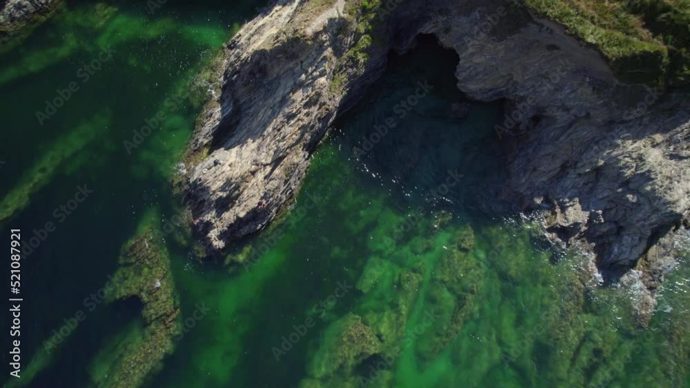 Drone view vertically climbing away from rocky coastline and cliffs in Cornwall, UK Drone view vertically climbing away from rocky coastline and cliffs in Cornwall, UK
