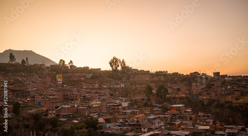  houses and trees in mountain at dawn, cusco, peru