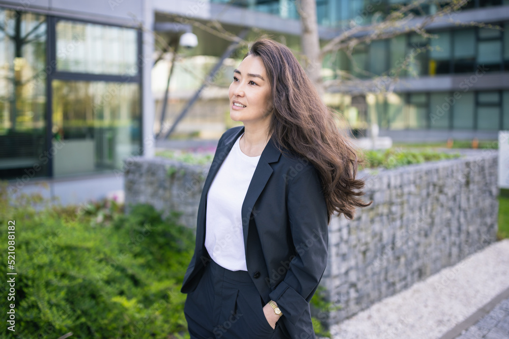 Asian confident business woman in suit. Bright future of career opportunities concept. Job, work aspirational banner, spring background of office center. Business people lifestyle. Copy space