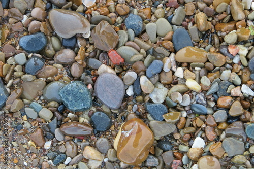 smooth wet rocks on beach sand