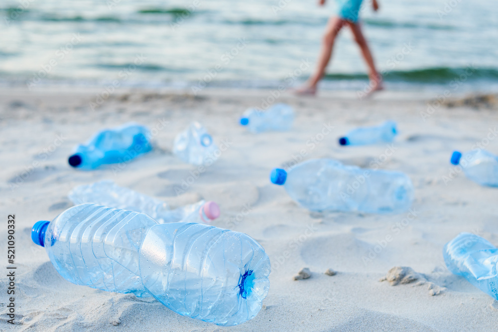 Plastic bottles on sea beach. Environmental pollution by plastic waste Plastic bottles on sea beach. Environmental pollution by plastic waste