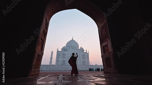 Silhouette woman in saree Indian dress costume dancing in Taj Mahal India