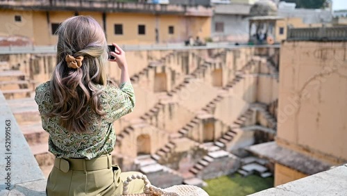 A woman visits the Indian an old step well in Rajasthan photo