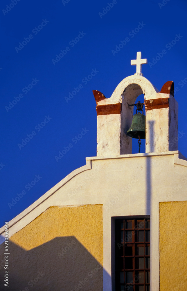 A little bell tower in Santorini, Thera, against the blue sky