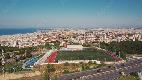 St Paul Stadium in the city of Thessaloniki in Greece seen from aerial drone perspective. Beautiful weather. Clear blue sky. High quality photo