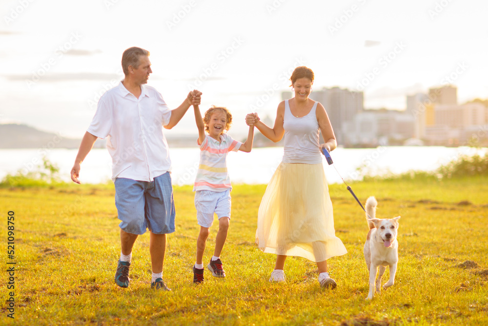 Fototapeta premium Family with kids running outdoor at sunset.
