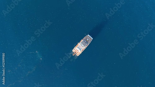 Small Yacht sailing and surrounded by hundreds of jellyfish, aerial

Drone view from mediterranean, israel, 2022 

 photo