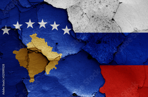 flags of Kosovo and Russia painted on cracked wall