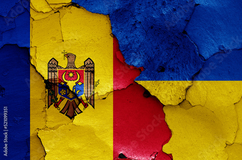 flags of Moldova and Ukraine painted on cracked wall