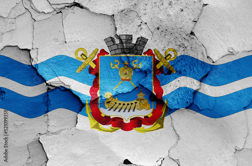 flag of Mykolaiv painted on cracked wall