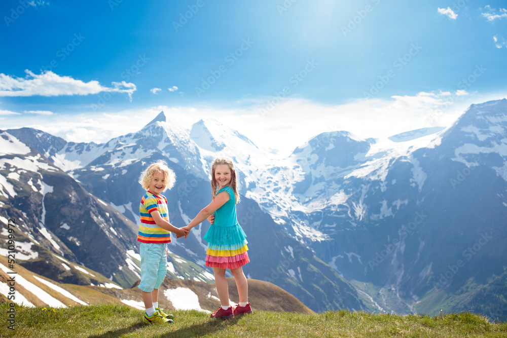 Fototapeta premium Children hiking in Alps mountains. Kids outdoor.