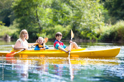 Child on kayak. Kids on canoe. Summer camping. © famveldman