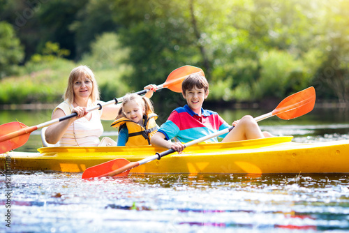 Child on kayak. Kids on canoe. Summer camping. © famveldman