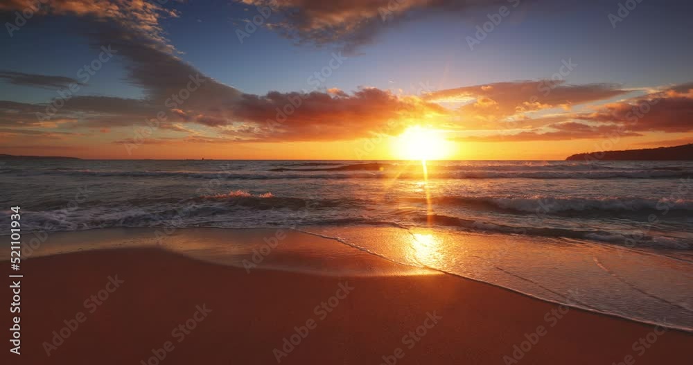 Beautiful ocean beach sunrise and splashing waves on the sea sand, 4K video of nature landscape, seascape view