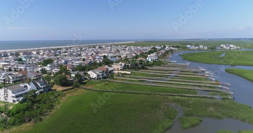 Drone shot of houses along the Intercoastal Waterway with Bird Island Wildlife Sanctuary off in the distance