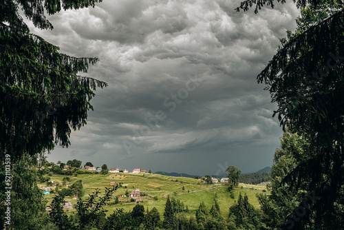 The rain starts in the mountains. Dark rain clouds covered the sky in Goah in summer. photo