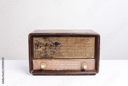 Antique radio receiver on white table, white background. Clipping path