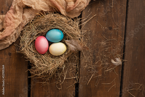 Painted Easter chicken eggs in a nest. Holiday Easter concept background. High quality photo