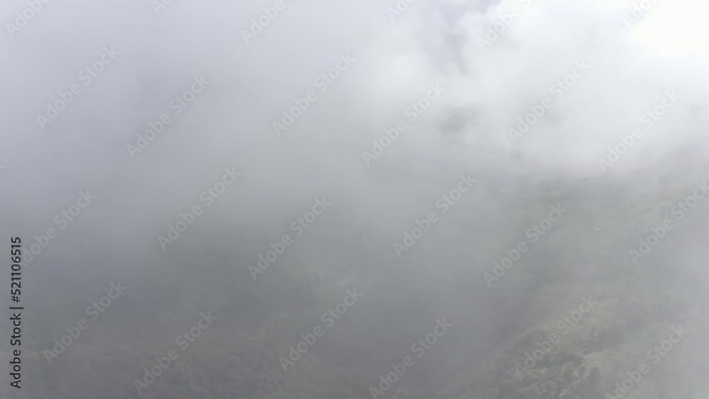Monsoon Clouds Enveloping Deep Mountain Valley With Evergreen Rainforest In Khasi Hills, Meghalaya India. Aerial Drone Shot Monsoon Clouds Enveloping Deep Mountain Valley With Evergreen Rainforest In Khasi Hills, Meghalaya India. Aerial Drone Shot