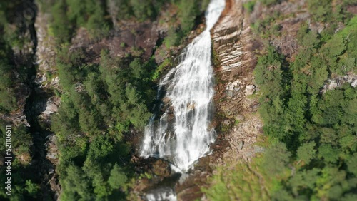 A tilt-shift video of the Svandalsfossen waterfall. Slow-motion. Pan down. photo