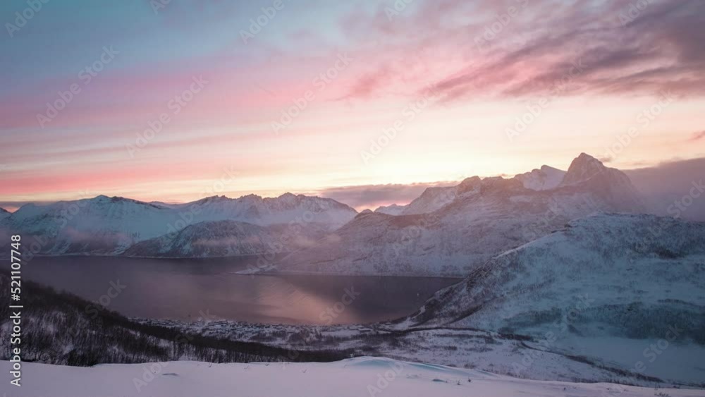 Sunrise over snowy mountain peak in blizzard on Segla mount in the morning at Senja island, Norway
