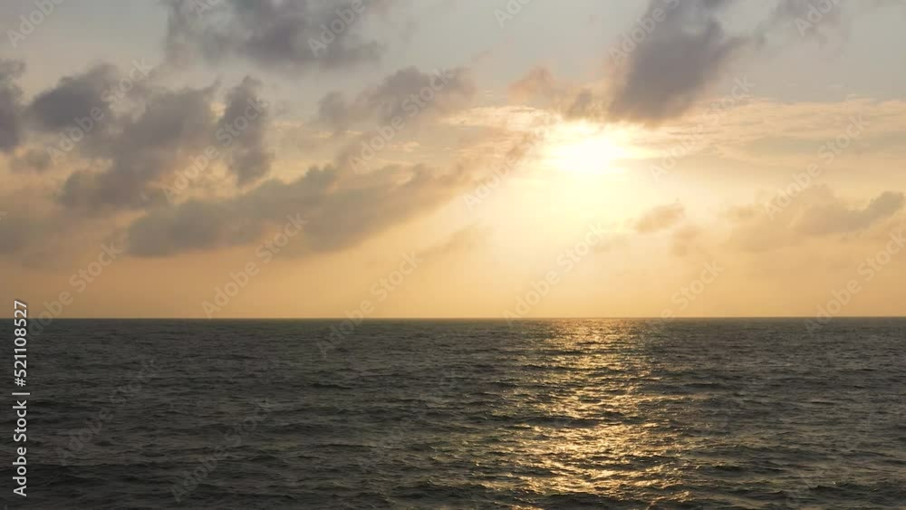 Top view of golden sky over the sea and reflection at sunset. Top view of golden sky over the sea and reflection at sunset.
