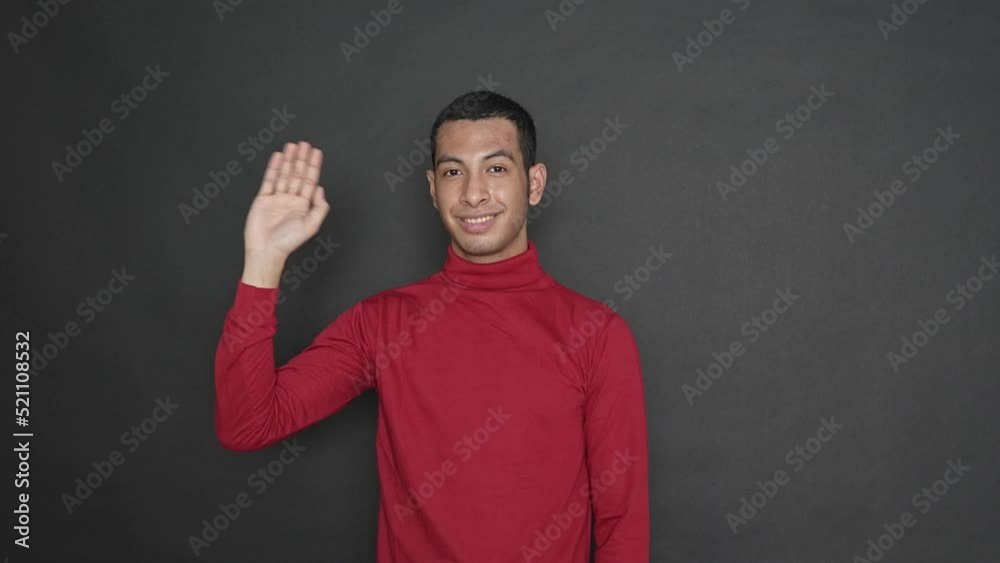 Expressive young man with waving gesture on a black background Expressive young man with waving gesture on a black background