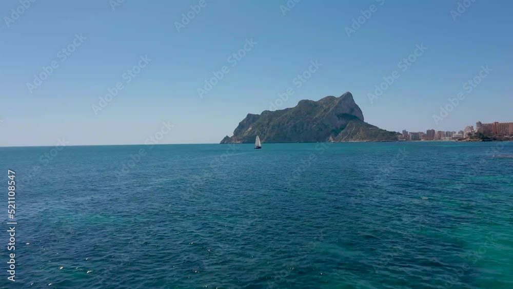Boat Sailing In The Ocean At Daytime In Calpe, Alicante, Spain. - aerial Boat Sailing In The Ocean At Daytime In Calpe, Alicante, Spain. - aerial