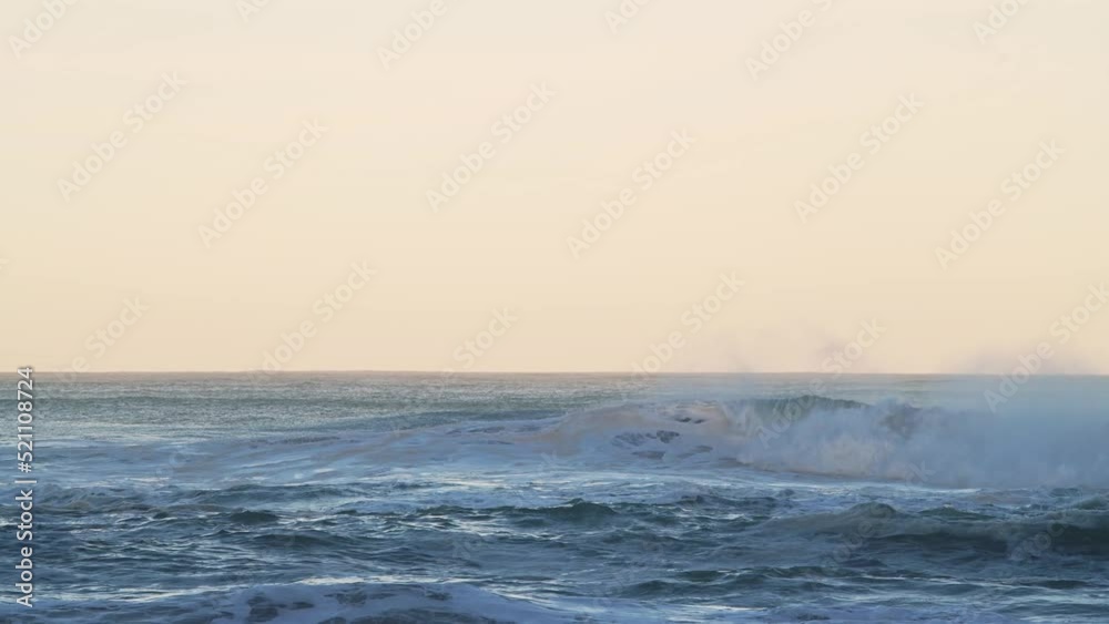 Big Waves Breaking Ocean Seascape Background with Copy Space in Orange Sunset Light, Sea Crashing Below Horizon from Low Angle Big Waves Breaking Ocean Seascape Background with Copy Space in Orange Sunset Light, Sea Crashing Below Horizon from Low Angle