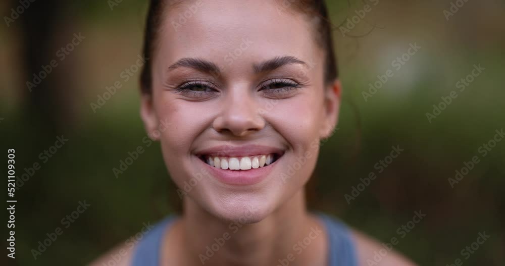 Close-up portrait of a woman smiling and looking at the camera in nature Close-up portrait of a woman smiling and looking at the camera in nature