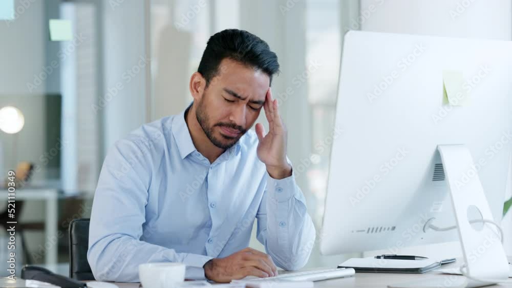 Tired, stressed and exhausted office executive with a headache reading an email on computer at work. Worried, anxious and unhappy manager trying to meet deadline with problems and issues in workplace