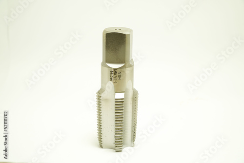 Tapping for threading in metal Tool for metal processing on a white background,industrial concept