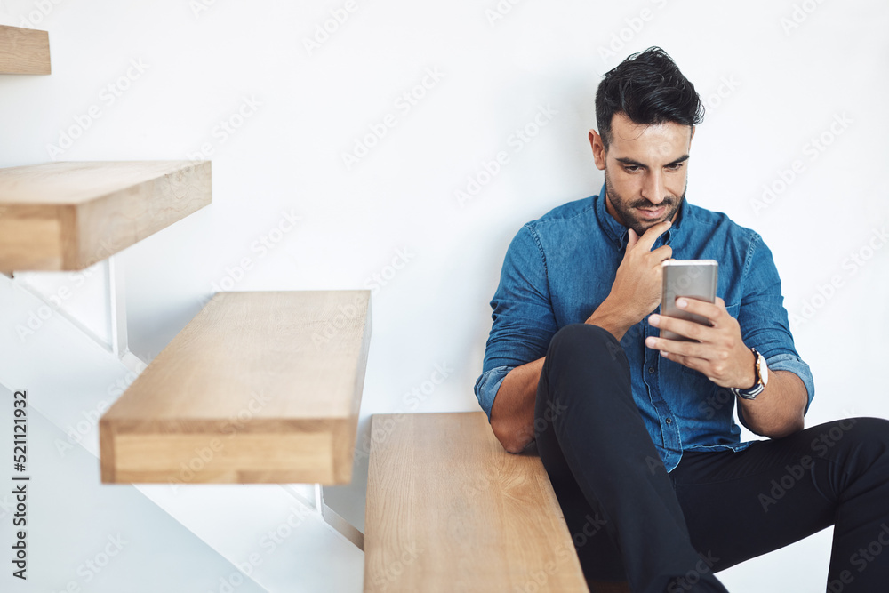 Male texting on a phone, browsing social media online while sitting on steps. Surfing the internet, Sharing information, networking and staying connected. Updating status and posting feed with an app Male texting on a phone, browsing social media online while sitting on steps. Surfing the internet, Sharing information, networking and staying connected. Updating status and posting feed with an app