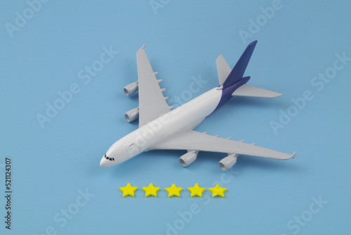 Airlines company feedback. Airplane model with five stars stickers on blue background.	