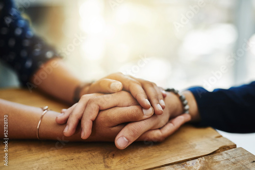 Holding hands, support and comfort of two people talking through a difficult problem. Closeup of friends showing care and love through a hard time, consoling each other and bonding photo