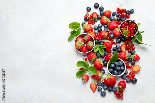 Various fresh berries on neutral background.