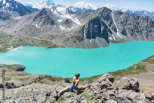 Girl doing yoga and leg-split near wonderful mountain landscape  lake  highland  peak  beauty world. Picturesque view near Alakul lake.