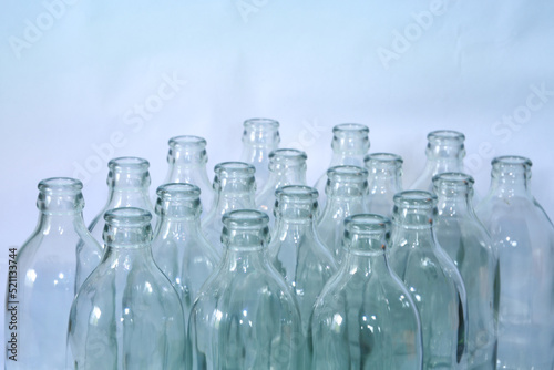 Emty bottles of soda unlabeled set with rows. food and drink industry background. 