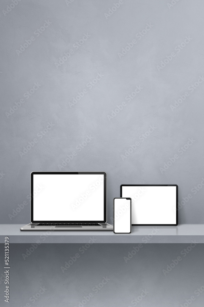 Laptop, mobile phone and digital tablet pc on grey wall shelf. Vertical background Laptop, mobile phone and digital tablet pc on grey wall shelf. Vertical background
