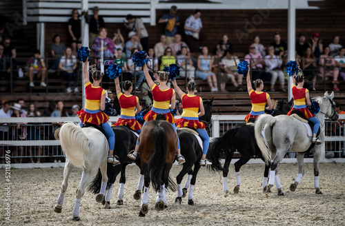 girls on beautiful and sporty horses show their skills at the equestrian festival