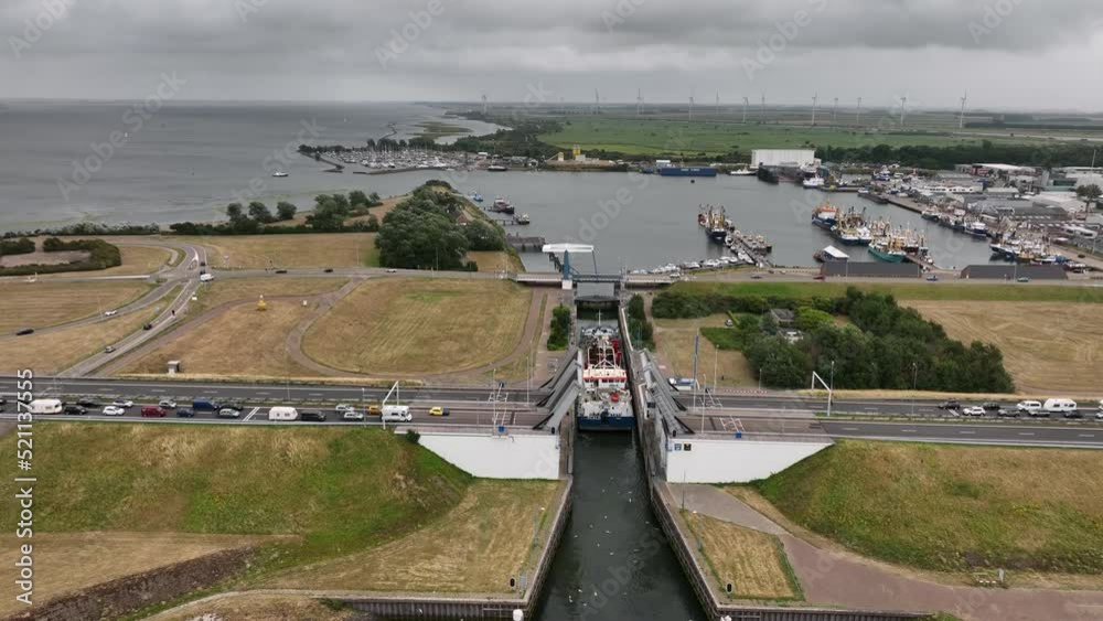 Ship going into Haringvliet locks, traffic waiting for bridge to lower; drone Ship going into Haringvliet locks, traffic waiting for bridge to lower; drone
